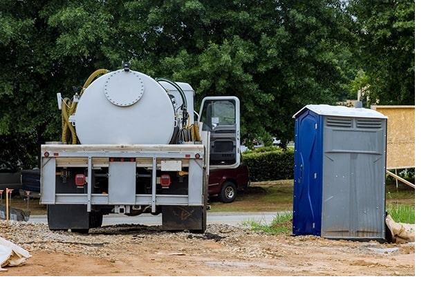 Miami Beach Portable Sanitation Group service truck parked beside a delivered portable restroom unit